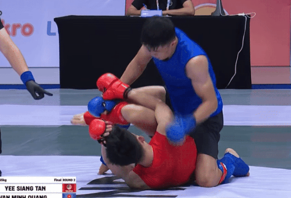 Võ sĩ Việt Nam trút mưa đòn xuống địch thủ Malaysia, giành HCV lịch sử tại SEA Games - Ảnh 1. Quàng Văn Minh (áo xanh) áp đảo Tan Yee Siang